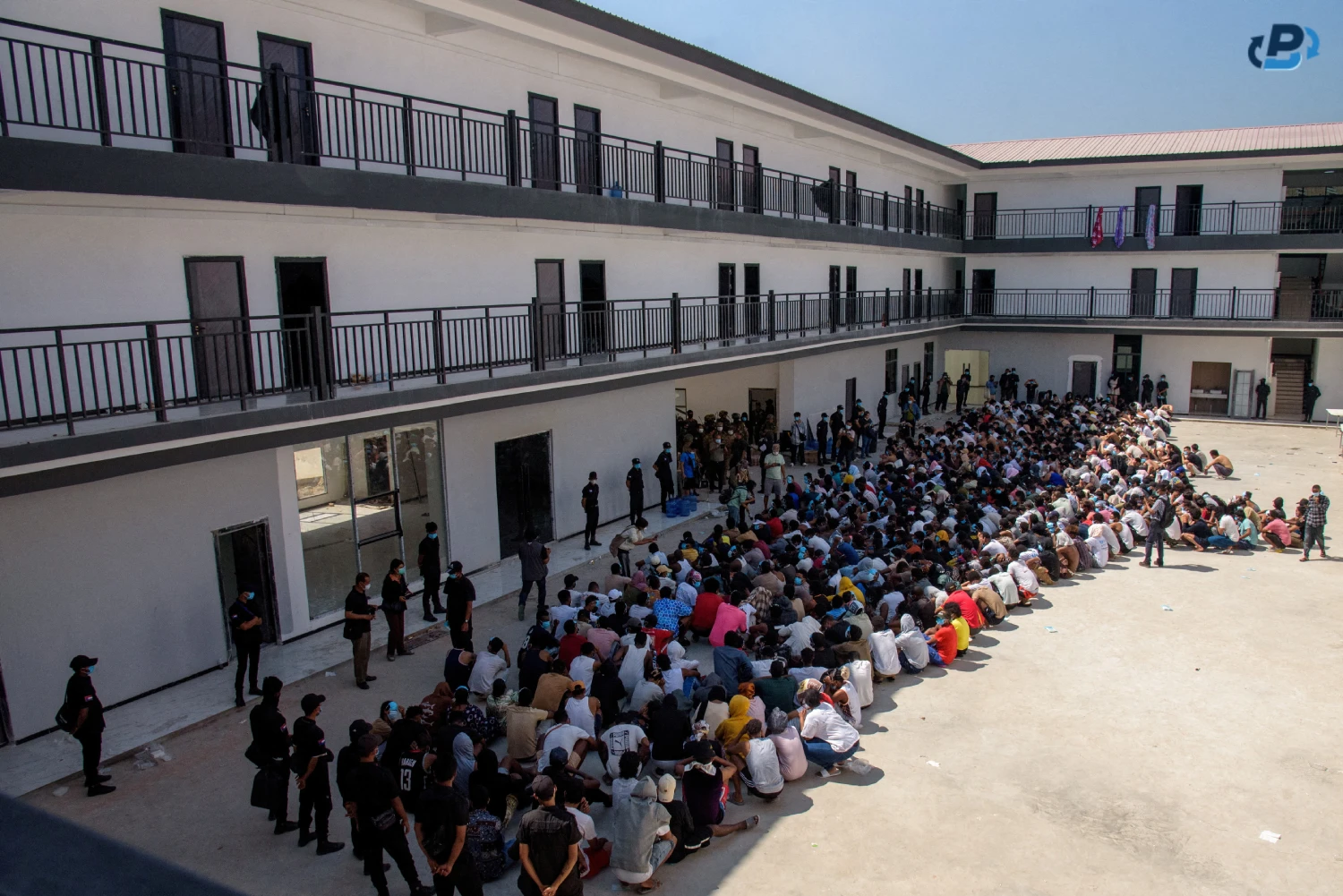 Surveillance photograph of a Myawaddy scam compound with residential complexes encircled by the treacherous Moei river
